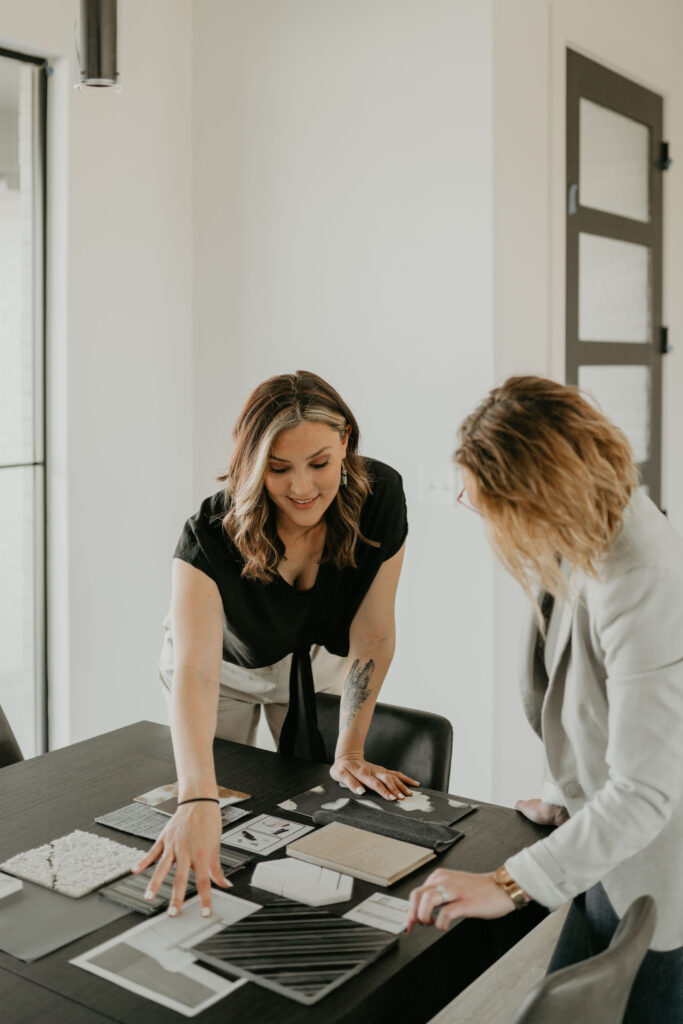 rooted-interior-design-wichita-ks-2025-year-in-review-interior-designer-presenting-materials-to-client-in-office-samples-on-table-design