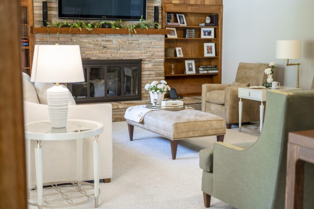 rooted-interior-design-wichita-ks-designing-flexible-spaces-living-room-with-leather-ottoman-recliner-white-sofa-walls-stone-fireplace-thoughtful-interior-design