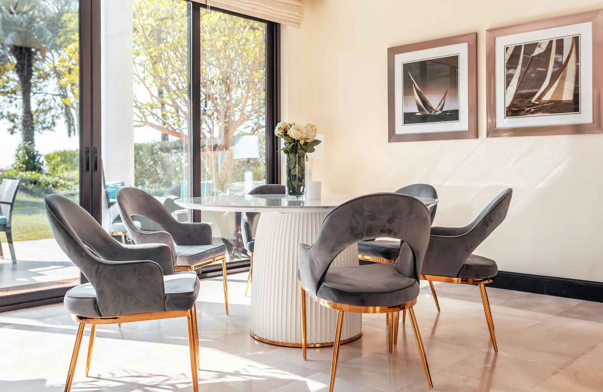 full-service-interior-designer-newton-ks-scale-and-proportion-in-design-dining-room-with-round-table-gray-chairs-large-glass-door-stylish-finish-selection