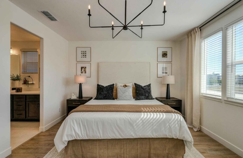 full-service-interior-design-newton-ks-working-with-an-interior-designer-minimalist-bedroom-iron-light-fixture-comfortable-furnishings-natural-light-stylish