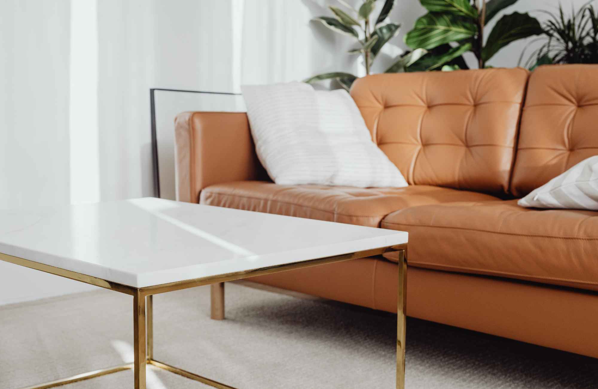 rooted-interior-design-eastborough-ks-working-with-an-interior-designer-leather-sofa-and-white-and-metal-coffee-table-curated-virtaul-interior-design