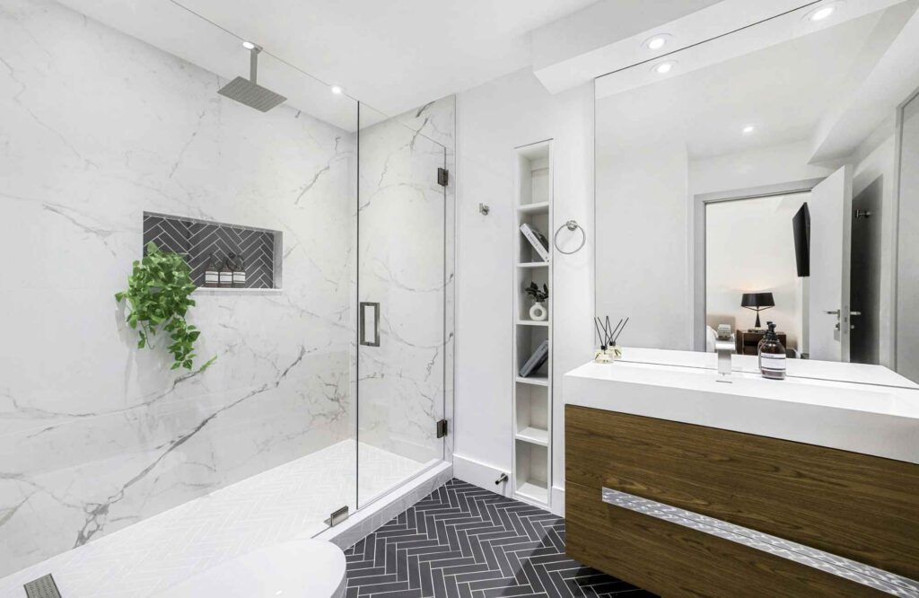 rooted-interior-design-wichita-ks-how-designers-source-materials-luxury-bathroom-dark-floor-tile-white-shower-tile-floating-vanity-thoughtful-virtual-design