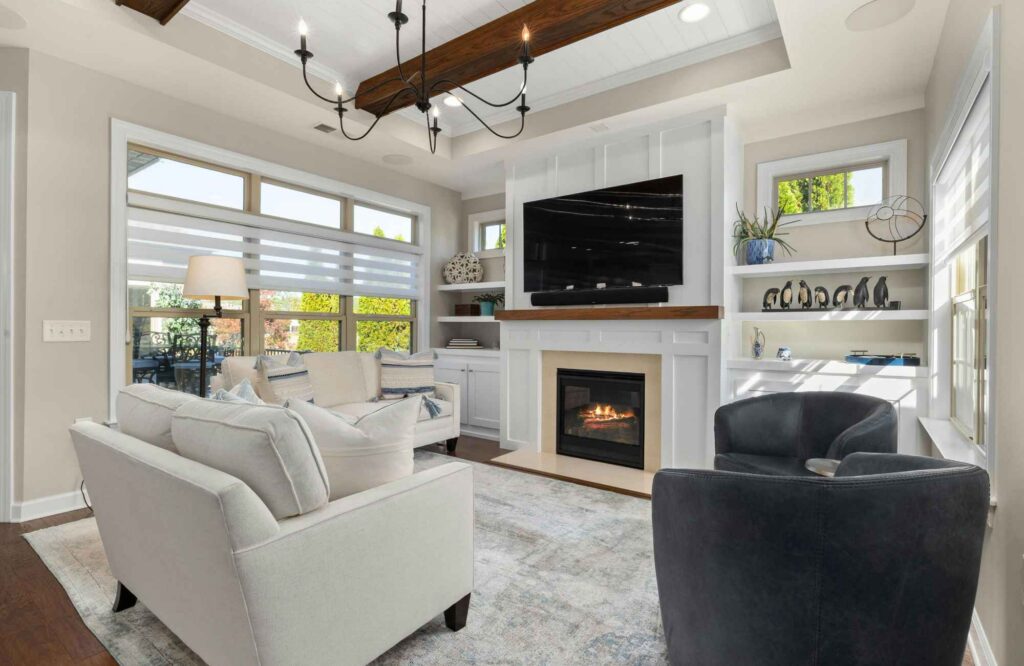 rooted-interior-design-wichita-ks-home-design-living-room-ceiling-beams-fireplace-with-built-in-cabinets-large-window-thoughtful-finish-selection